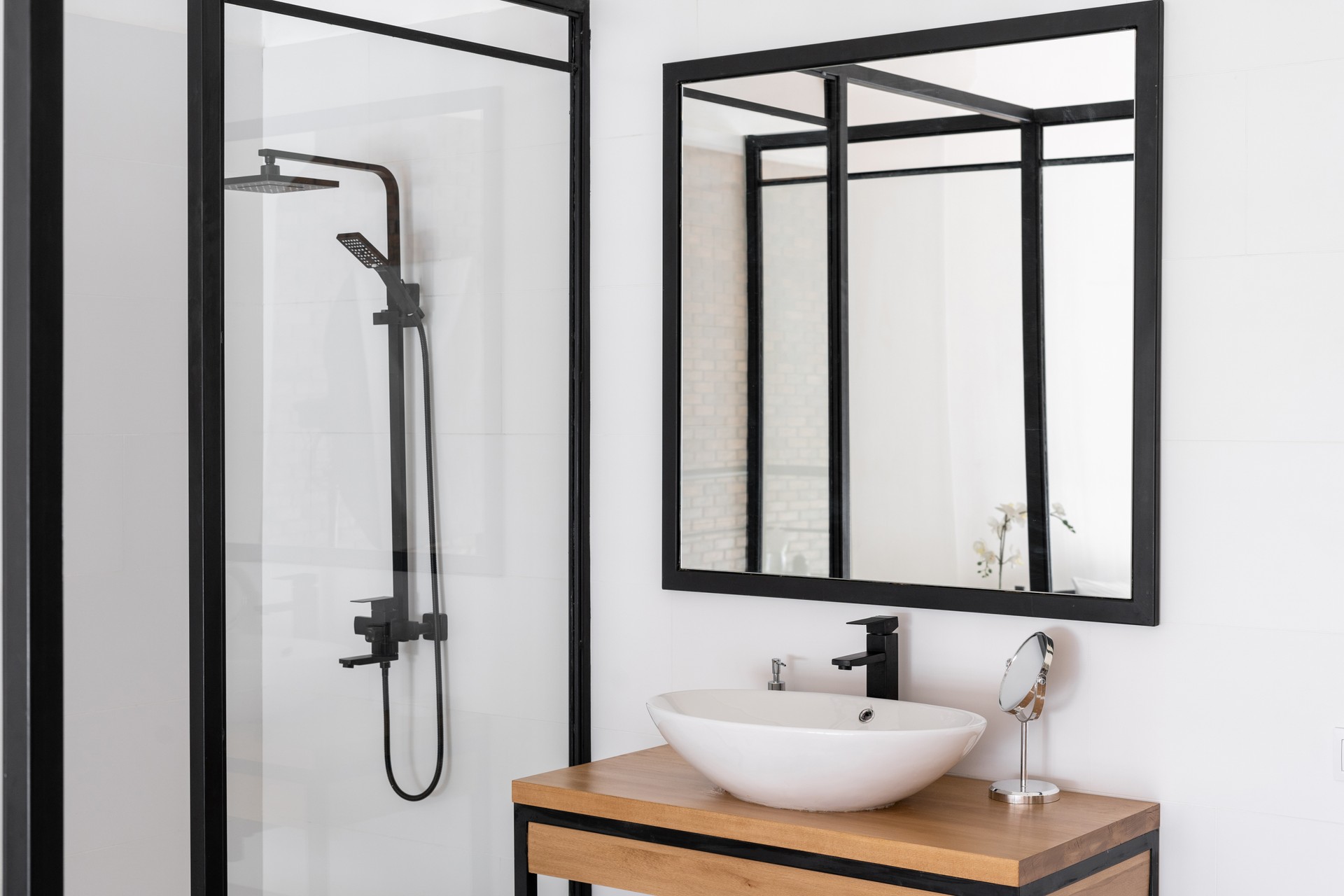 White sink, mirror and shower in bathroom